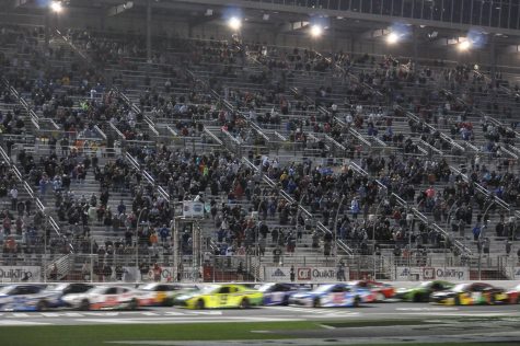 Crowd stands for the end of the race that saw two overtime attempts. The checkered flag is waved as Ty Gibbs takes the win. 