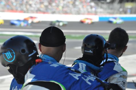 Pit crew overlooks the chaos of the Folds of Honor QuikTrip 500. The increase of the banks from 24 to 28 degrees forced drivers to race as they would at a superspeedway, with the ensuing laps seeing many wrecks.