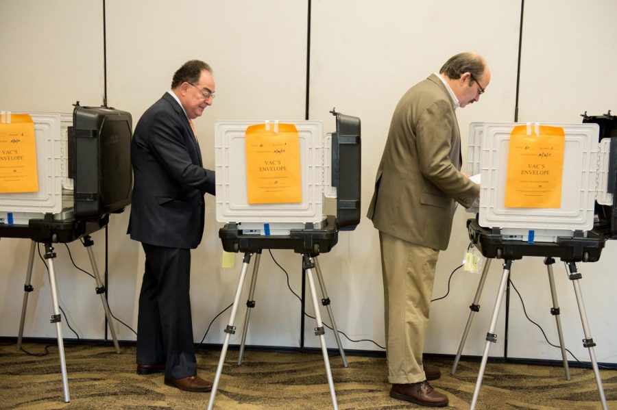 Two citizens voting during an election. Discussion of what the legal age should be in order to vote has been argued over for as long as democracy has existed. 