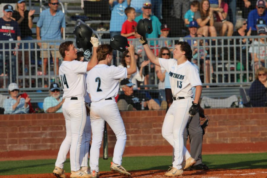 Sophomore Jack Ryan celebrates with senior Alex Ukleja and sophomore Heath Whitlock after Ryan’s three-run homerun in the fifth inning. Starr’s Mill gained a slight advantage over McIntosh in the region standings with the 9-4 win Tuesday night.