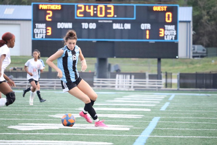 Sophomore Mia Hargrove maneuvers around opponents in order to shoot. Hargrove scored the first of the team’s three goals in the second half to help the Lady Panthers advance in the state playoffs. 