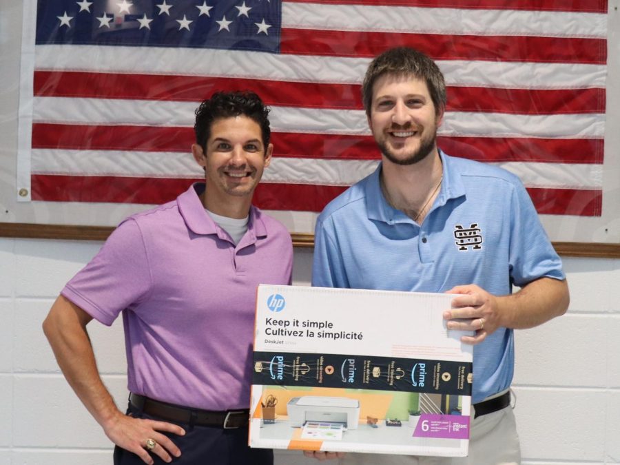 Math teacher Nick Castagna stands alongside Tim Monihan from Farmers Insurance. Castagna, a Starrs Mill alumnus, is dedicated to making the learning experience enjoyable for his students.