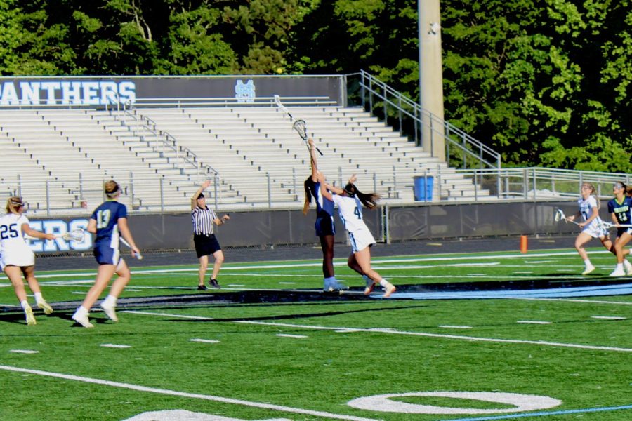 Sophomore Sunny McQuade, senior Emma Grace Hepler, and junior Siena Kamal fight for the draw control on the center circle in the semifinal round of the A-5A GHSA State Playoffs. Hepler and McQuade combined for nine total draw controls in a game where every draw was crucial. 