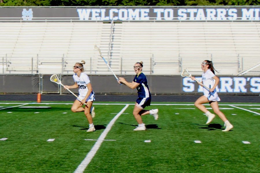 Senior+Emma+Grace+Hepler+carries+the+ball+into+the+attacking+third+of+the+field+while+avoiding+a+Northview+defender.+Hepler+combined+for+five+goals%2C+two+assists%2C+and+seven+draw+controls.+Hepler+finished+as+the+leader+in+points+for+the+Panthers+this+season.+