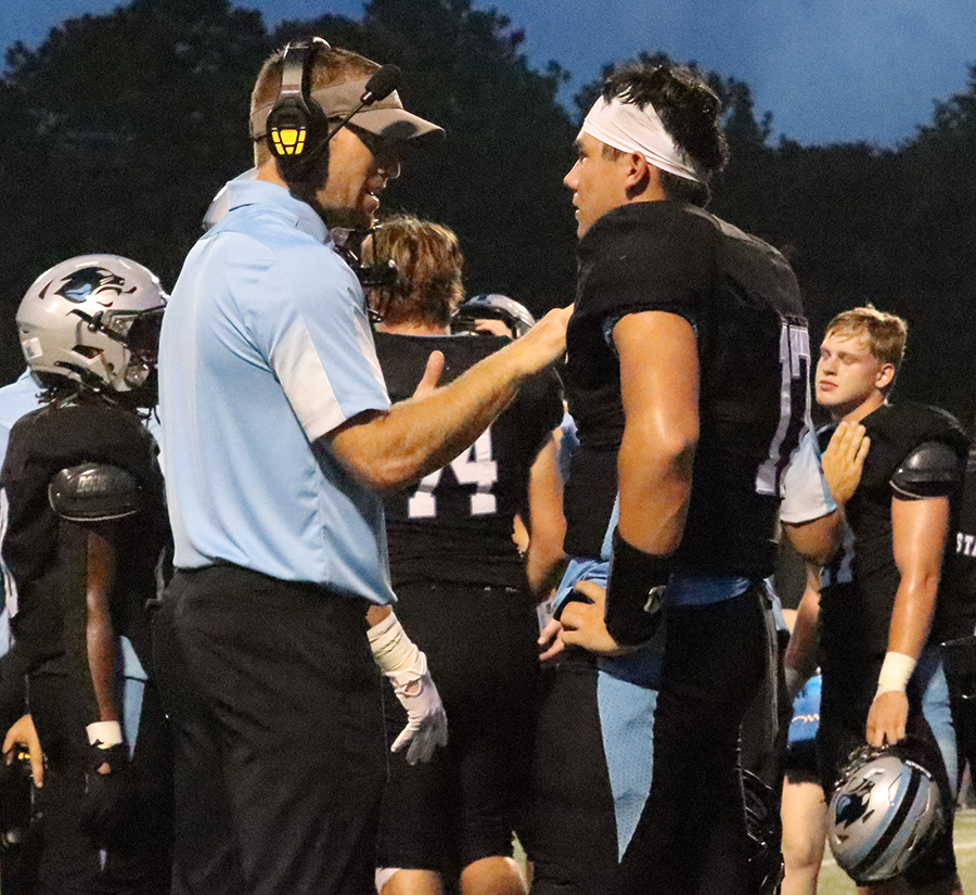 Coach Chase Penland talks to sophomore Logan Inagawa before the game begins. Starr’s Mill trailed East Coweta 14-12 at halftime. Inagawa connected with senior Josh Phifer on a 13-yard touchdown pass in the third quarter to help the Panthers regain the lead.