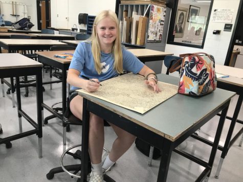 August 18, 2022 - Sophomore Megan Ritchey continues to add routes to her never-ending maze drawing in Todd Little’s printmaking class. Although it was not required to decorate her art folder, she chose to do so in order to personalize it by creating a maze with no solution. 