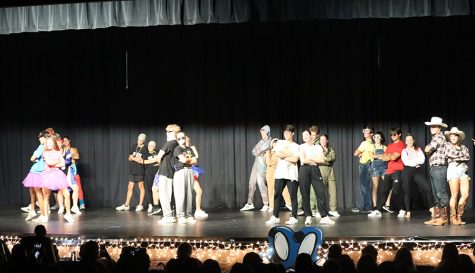 Dancing with the Pantherettes pose on stage. At the end of the show, all the participants went on stage to perform the closing dance for the annual fundraising event.