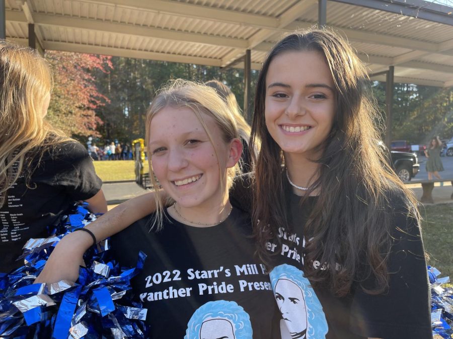October 27, 2022 - Color guard teammates freshmen Taylor Preble and sophomore Blerta Basha prepare for the Homecoming parade. The parade was a continuation of the week’s activities that will end with the dance Saturday night.