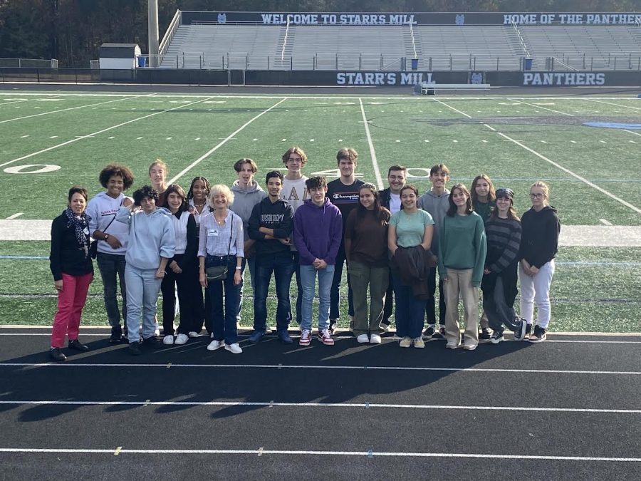 French foreign exchange students gather for a photo in Panther Stadium. The program offers participants the opportunity to experience American teenage life. 