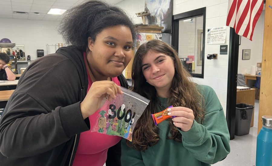 November 1, 2022 - Junior Angelize Archer and freshman Sophia Lombardo show off their candy from Halloween. Students started the week by trick-or-treating Monday night. 