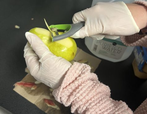 November 11, 2022 - Sophomore Clare Manetti peels a pear to make baby food in Food and Nutrition class. After they make the baby food, they will compare it to store bought baby food, and then give their baby food to staff with babies. 