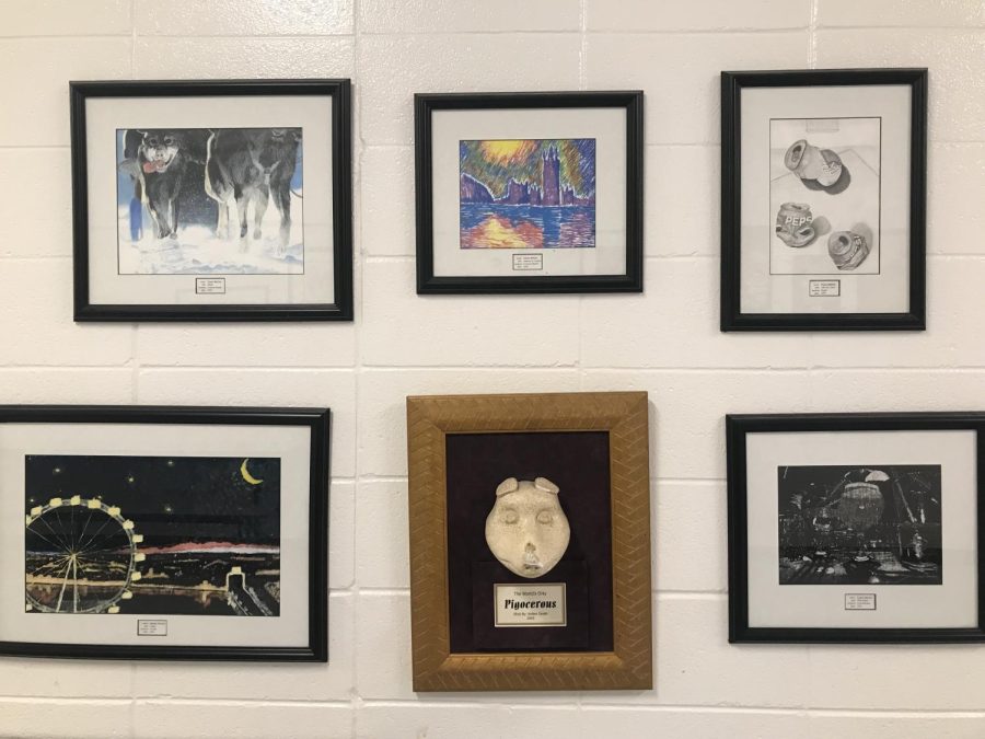 December 1, 2022 - For years, Starr’s Mill students have had their artwork displayed in the hallway between the cafeteria and auditorium. “It seemed like a good idea at the time. I wanted to start doing something, so I started collecting student art and created an art hall of fame,” visual arts teacher Todd Little said. “It started around 2001. I stopped about 2-3 years ago, because I lost my framer.” 