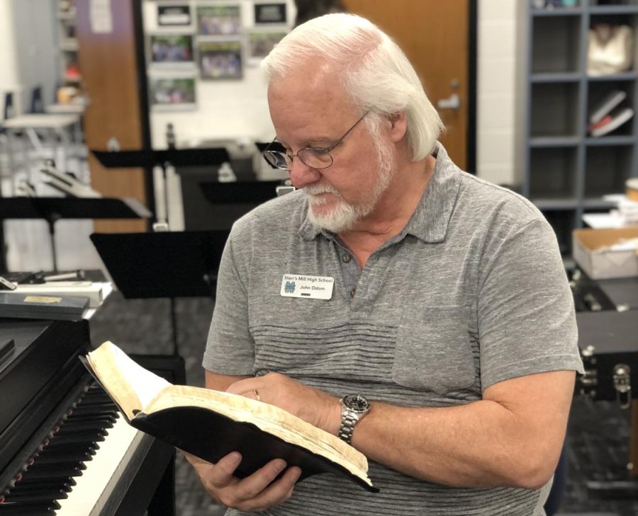 Chorus director John Odom ranks the Bible atop his list of favorite books. Many believe this book is an instructional text related to how to live your life. 