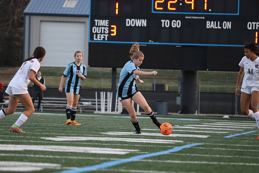 Sophomore Grace Weatherly moves the ball up the field.  The team used ball control to defeat Whitewater 6-0.