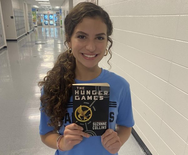 Freshman Landry Hunter holds “The Hunger Games” by Suzanne Collins. The young adult novel focuses on survival of the fittest, and psychological and mental strength.