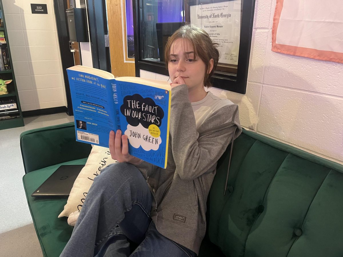 Junior Riley Gibbas reads “The Fault in Our Stars” by John Green. The message of this young adult fiction novel is to embrace life and love.