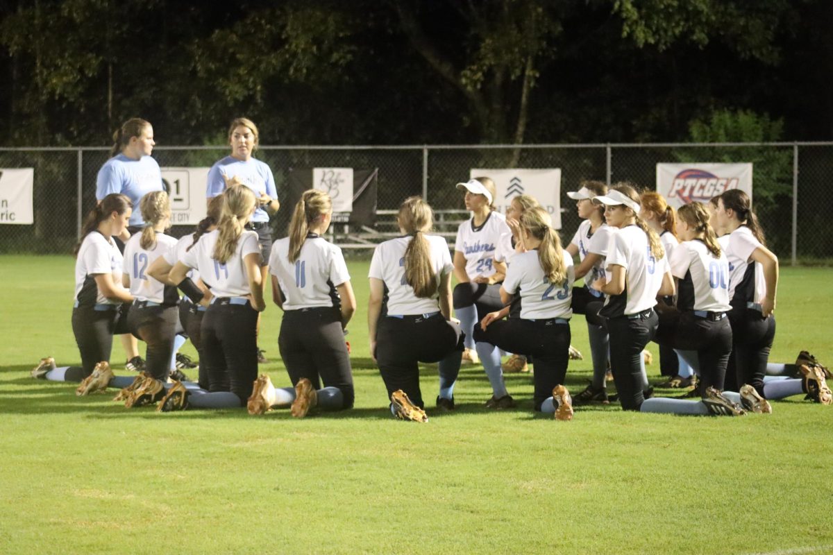 Head coach Ashley Smith (right) and assistant coach Jordan Childress (left) talk with the team after their win on Tuesday night. The Panthers triumphed over Fayette County High School with a 18-3 win. 