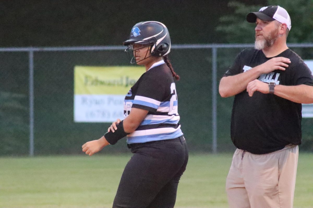 Senior Tyanna Smith stands on first after getting the team’s first hit in the bottom of the 2nd inning. Despite the 20-0 loss to region opponent Whitewater, the team is putting more balls into play.