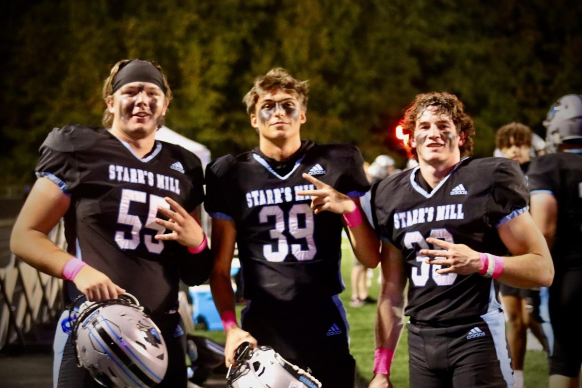 Seniors Jacob M. Spitznagle, Hunter Meeks, and Max Prozny pose for a picture together on the sidelines. Meeks and Prozny are kickers, while Spitznagle is a part of the teams offense. 