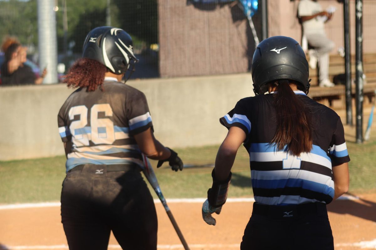 Senior Tyanna Smith and junior Emma Catherine Arnold walk toward the dugout after scoring a run. The Panthers said farewell to their seniors on Senior Night. 