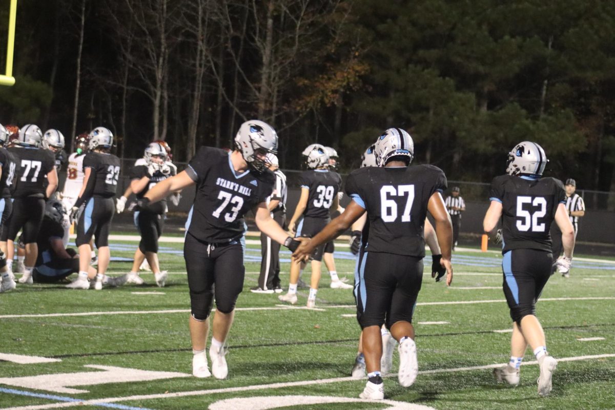 Juniors Ben Anderson and Jared Moore high-five after the Panthers score and the special teams unit goes onto the field. After defeating New Hampstead and Central, Starr’s Mill will host a state semifinal game for the first time in school history.