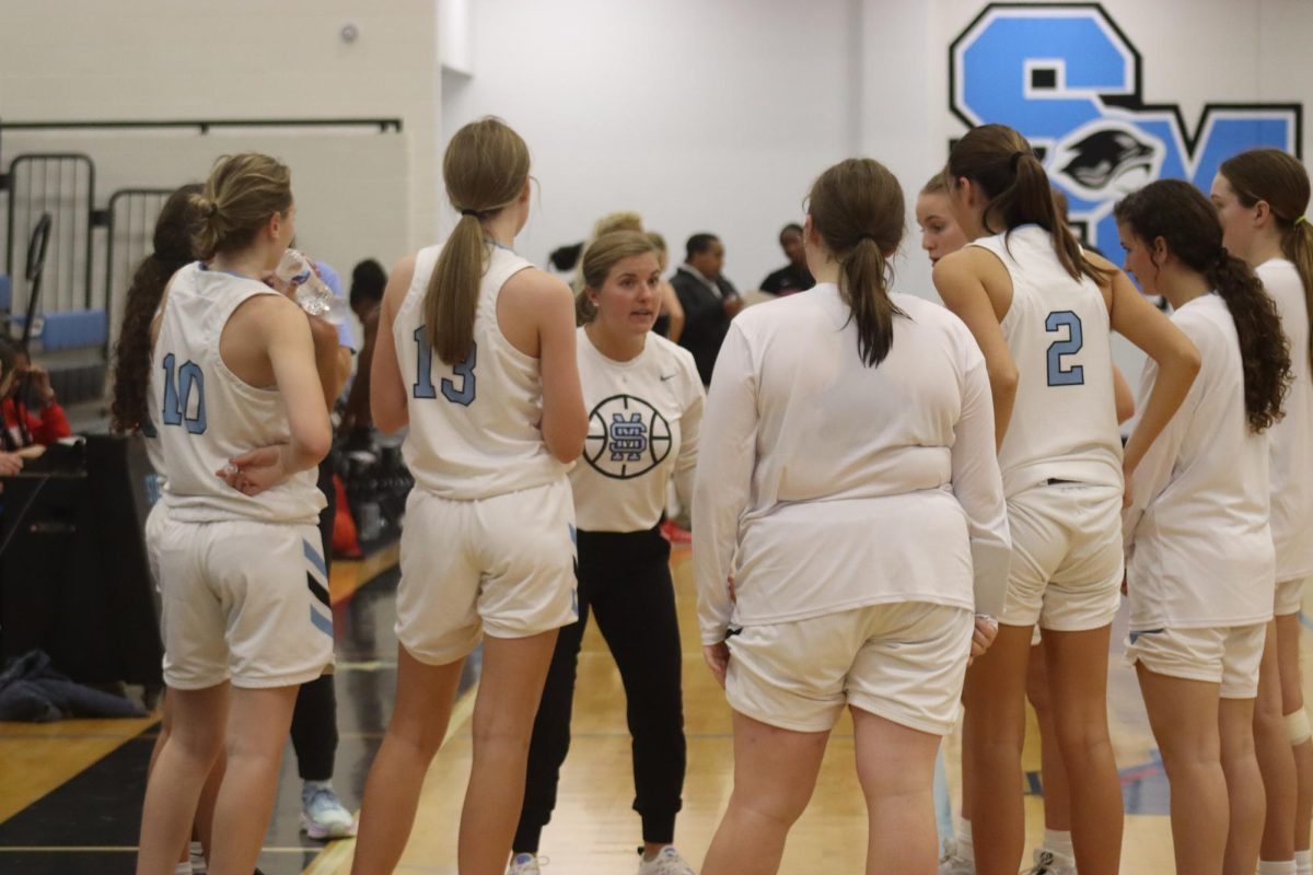 JV+girls+basketball+head+coach+Peyton+Dean+talks+to+her+players.+The+young+team+showed+lots+of+potential+in+Wednesday+night%E2%80%99s+win+against+Woodward+Academy+26-14.