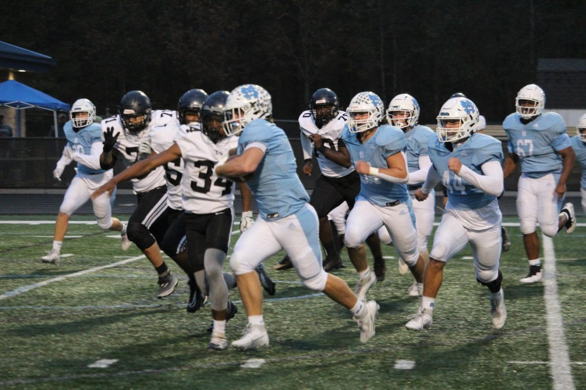 Junior Jeremiah Potter runs the ball as the Raider defense pursues him. Potter scored two touchdowns for the Panthers in the second quarter of the game. He ran 6 times for 47 yards and two touchdowns in the 48-0 win.