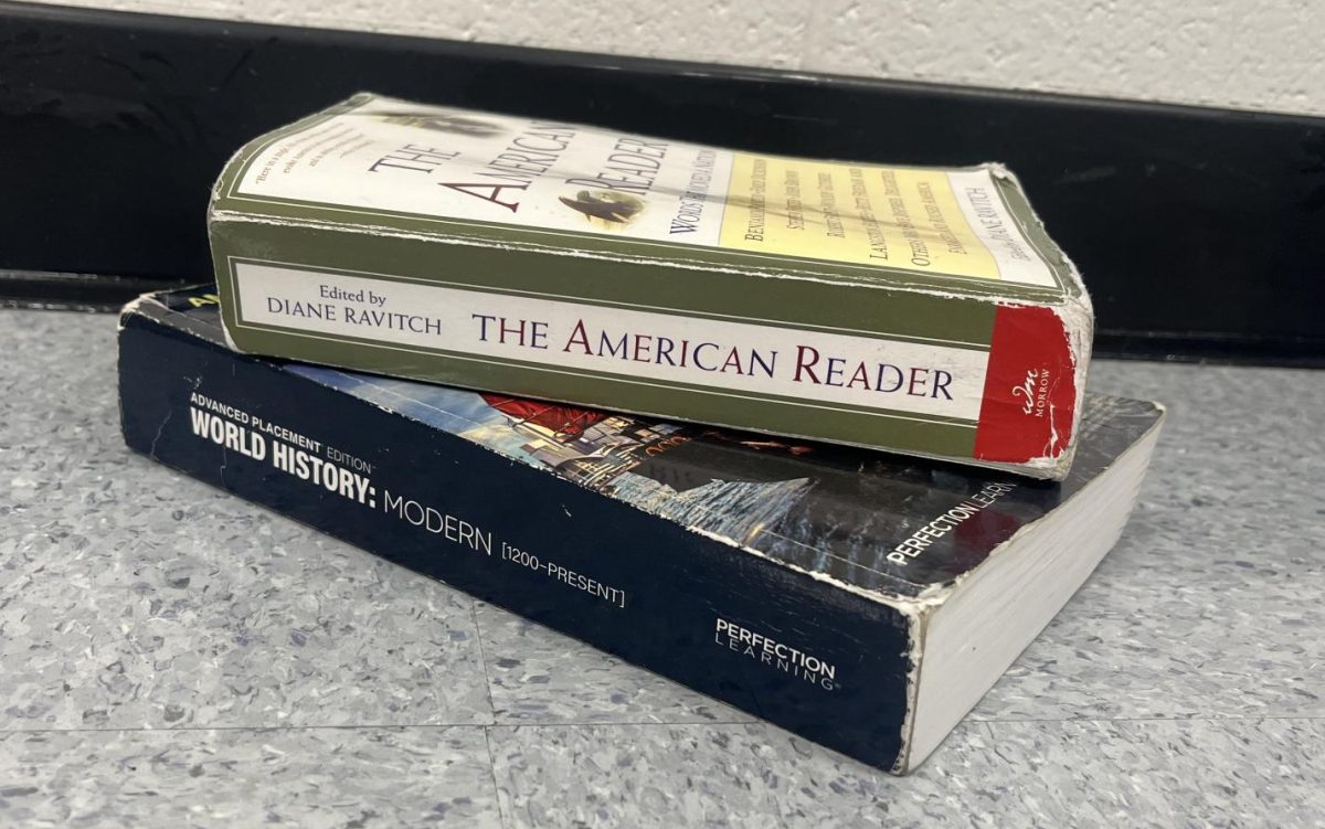 Stack+of+AP+books.+The+AP+cap+for+students+will+change+for+the+upcoming+2024-2025+school+year.+Sophomores%2C+juniors%2C+and+seniors+can+take+up+to+six+AP+courses+and+freshmen+can+take+up+to+two.+