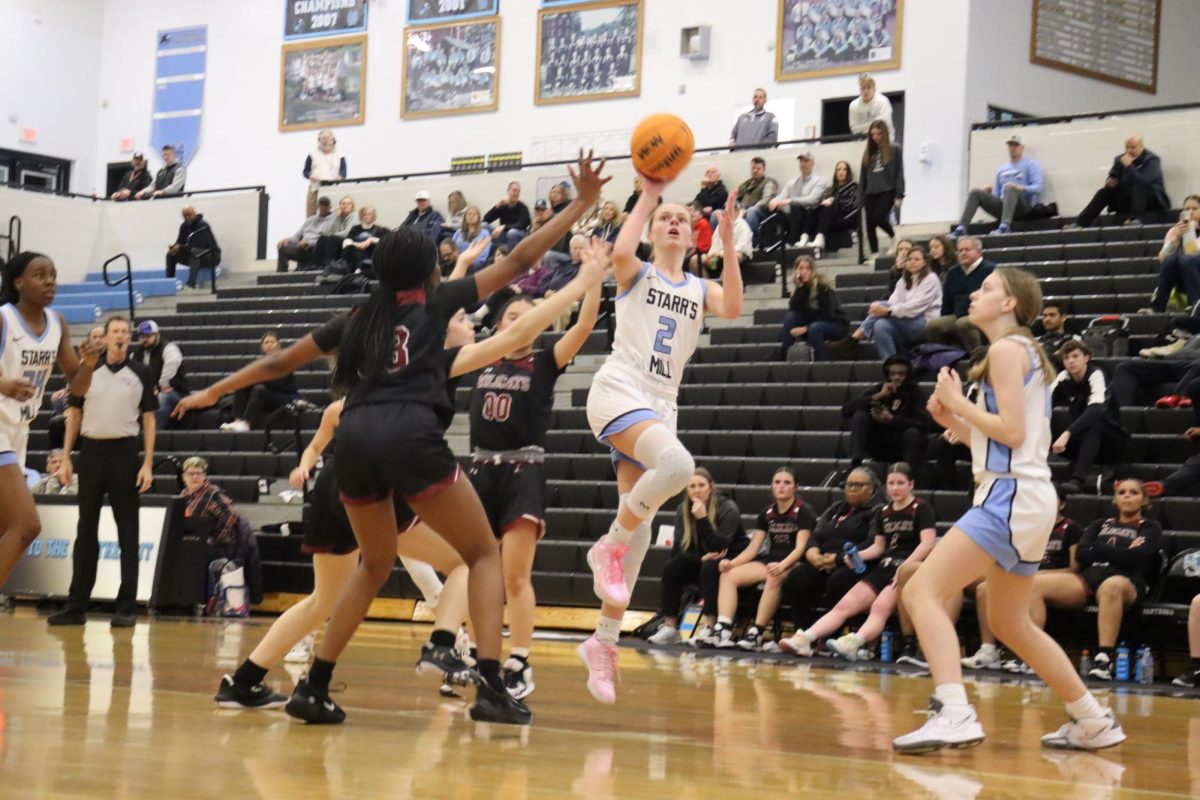 Senior+Brooke+Herdman+attempts+a+shot.+Herdman+helped+lead+the+team+in+points%2C+scoring+a+total+of+13+for+her+team.+The+40-point+win+over+Whitewater+moves+Starr%E2%80%99s+Mill+into+second+place+in+the+region.