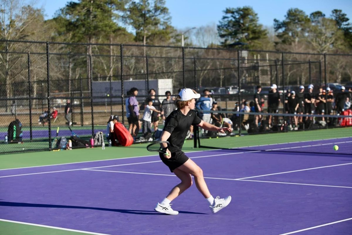 Senior Oliver Wysong prepares to return a hit. Both Starrs Mill teams defeated Trinity to remain unbeaten in region play. 