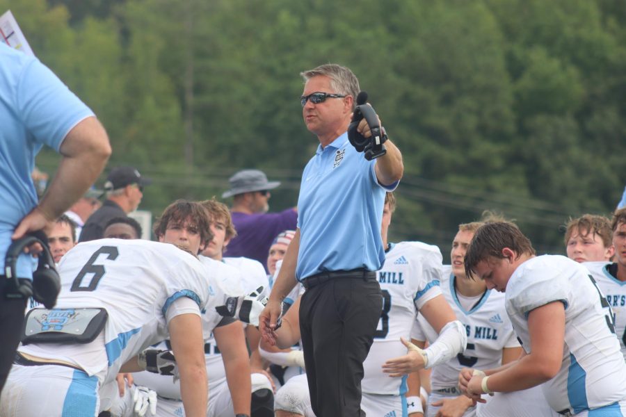 Head coach Chad Philips gives a post-game speech at East Coweta. After 34 years of coaching high school football, Phillips announced his retirement.