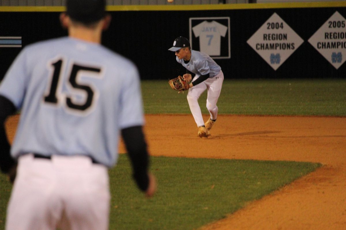 Eighth grader Maddox Mothershed stops a ground ball hit by a Locust Grove batter. Head coach Taylor Sweeney credited the 3-2 win to successful fielding.