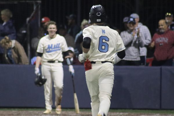 Senior Bo Walker walks back to the dugout after hitting a home run. Walker hit two home runs in the 6-0 win over McIntosh.