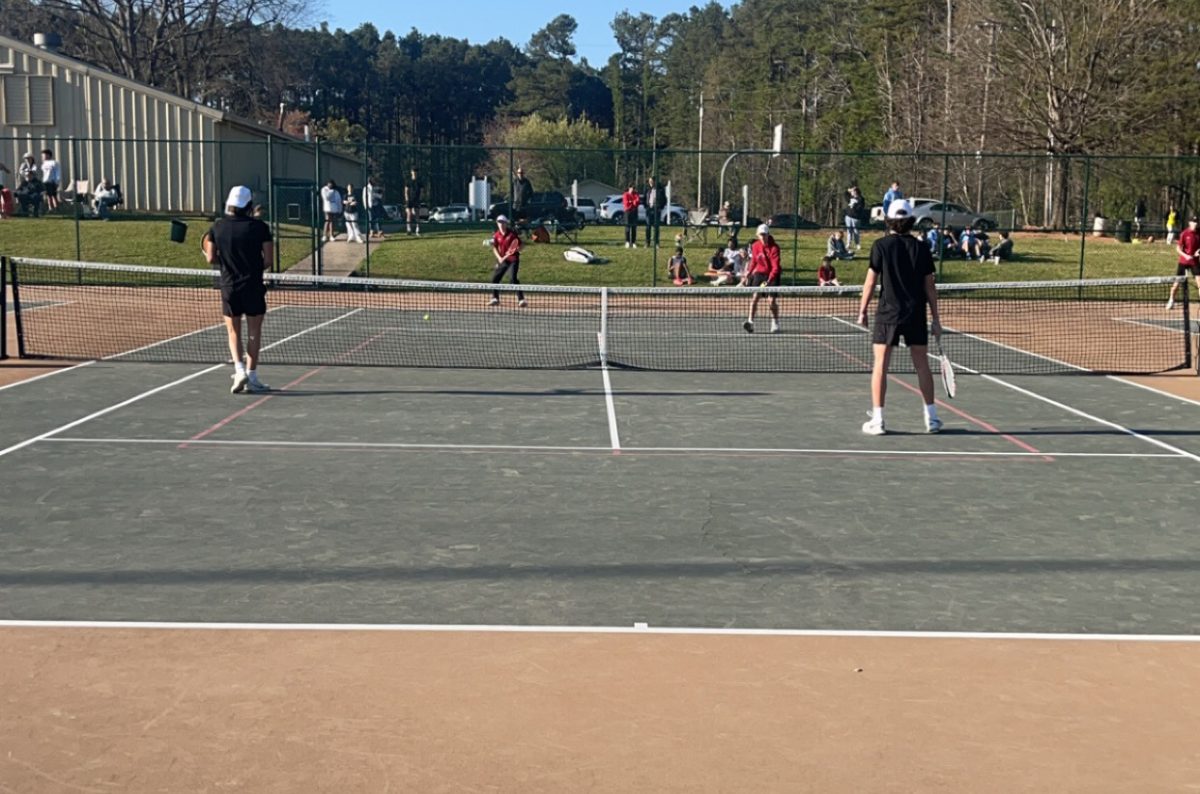 Sophomores Matthew Wysong and Alex Ruiz warm up with Whitewaters line 1 doubles players. Starr’s Mill will compete against McIntosh next Tuesday at the Peachtree City Tennis Center.