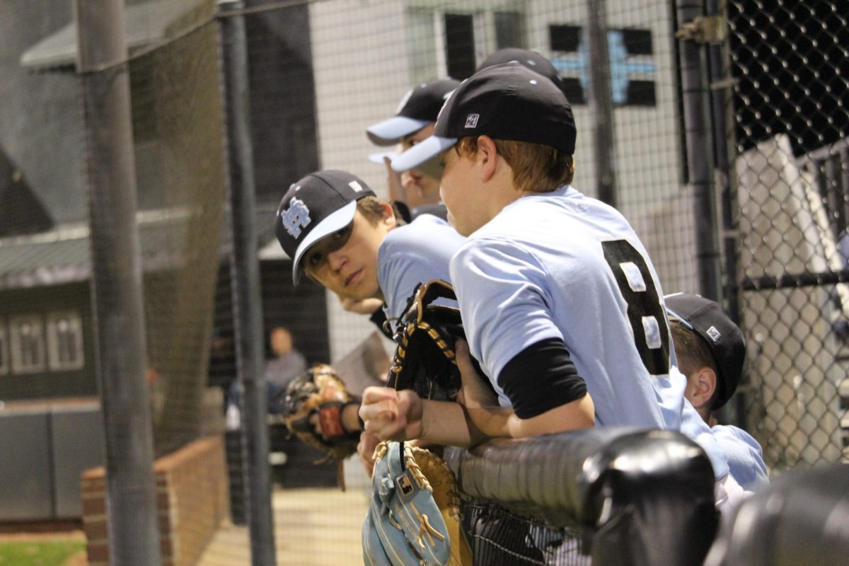 Members of the freshman baseball team watch from the dugout. The freshman team consists of 17 8th graders and only 2 freshmen, which is the most middle schoolers the team has had. The shared goal of the team is to improve their skills to play for JV or varsity in the future. 