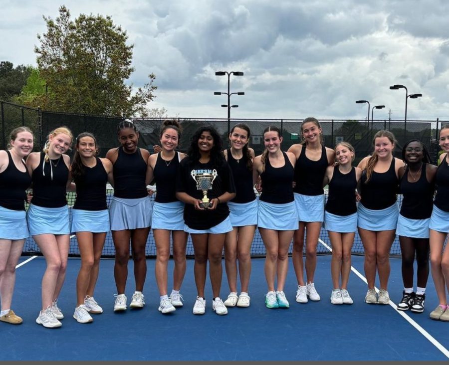 Senior Vaishnavi Jayakumar holds the first place trophy with the rest of the girls tennis team by her side. In the first round of the state playoffs, the girls host Westover at 4 p.m. today at Whitewater Creek, while the boys travel to Cairo tomorrow. 