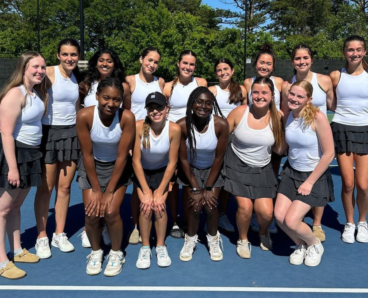 Girls tennis poses after defeating Wayne County, 3-2. Both tennis teams are elite eight-bound, but have had very different paths to get there. 