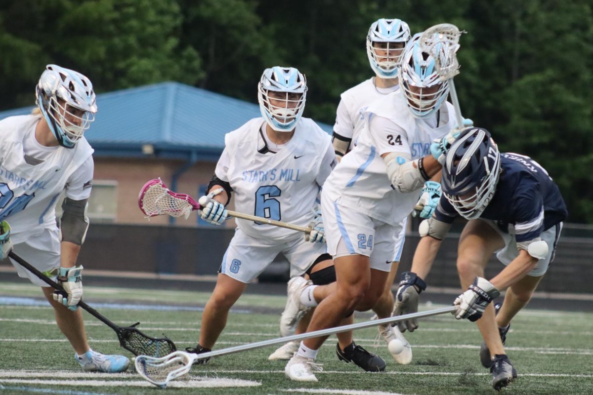 Seniors Taylor Ratinaud (#27) and Conor Stone (#6) go for possession of the ball. Both boys scored two goals, contributing to the 11-3 win against Pace Academy. 