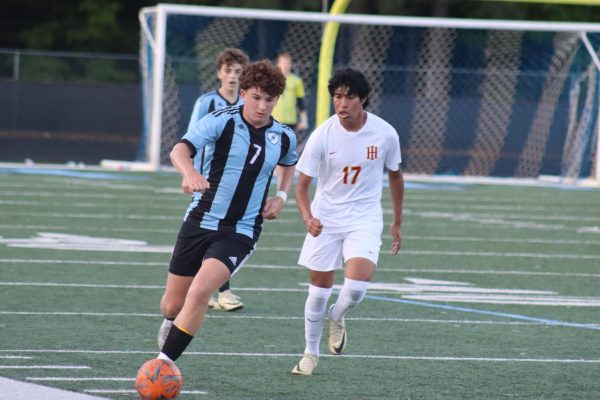 Junior Grant Ferron dribbles the ball up the field. The Panthers put up a good fight against the Holy Innocent but fell short, losing 3-1.