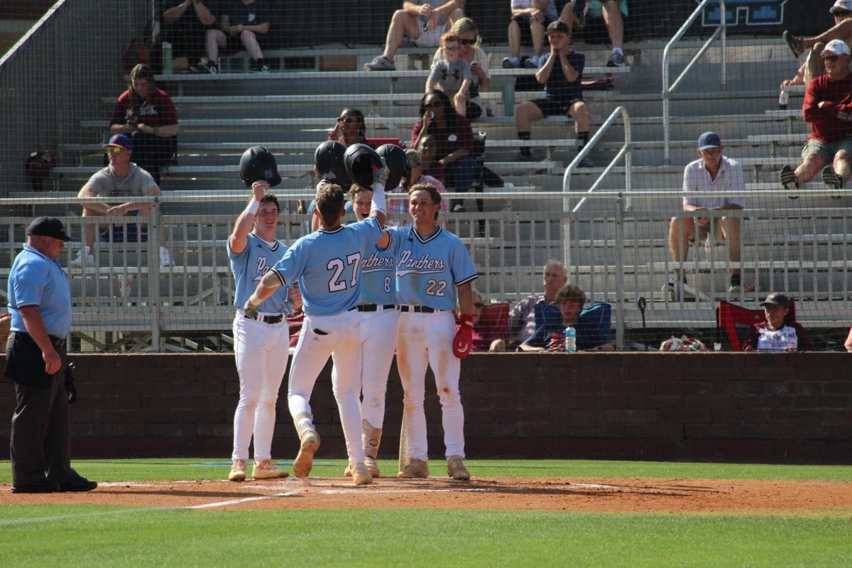 Seniors+Max+Prozny+and+Jack+Ryan+and+sophomore+Erik+Lundstrum+celebrate+sophomore+Brock+Rein+after+a+run.+The+Panthers+beat+the+Cadets+11-1+and+14-0+in+a+double+header+last+Wednesday.