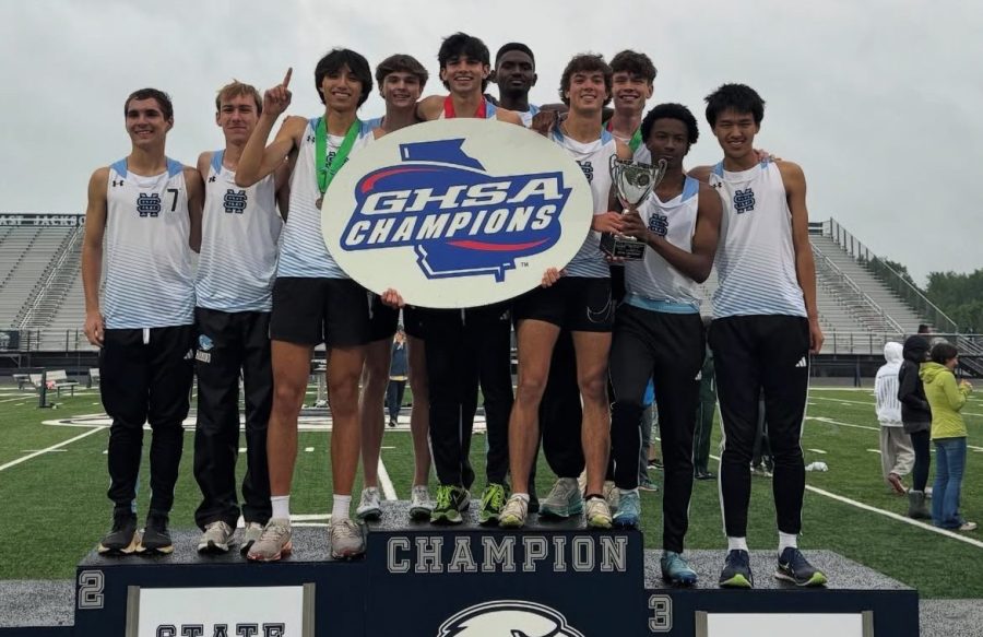 Boys track and field team stands atop the podium. The boys team earned the state title for the first time in school history, while the girls finished sixth.