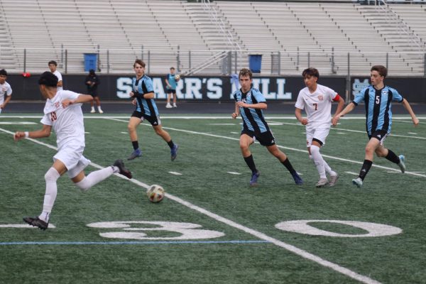 Elijah Hamming, Luicano Ziminov, and Aaron Blair (left to right) attempt to gain possession of the ball.  The varsity boys soccer team ended their season with a loss against Centennial, 3-1. 