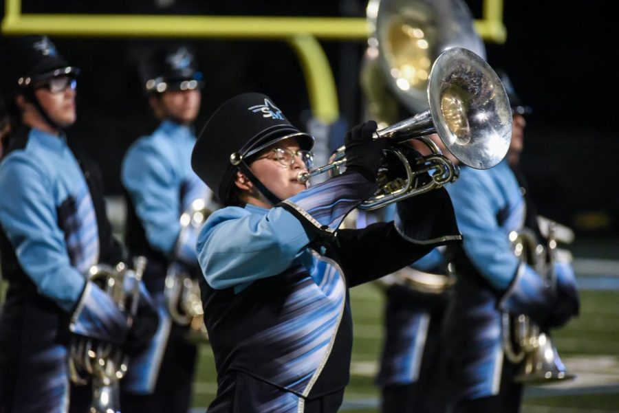 I play my solo at a home football game. The band program has provided a community of support through the ups and downs I experienced in high school.