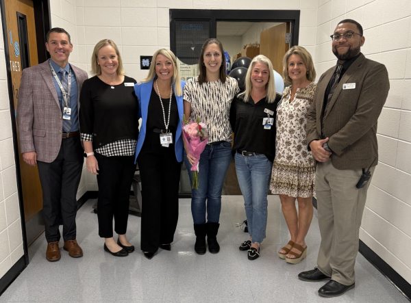 Physics and environmental science teacher Samantha Krage (middle) has been named this year’s Teacher of the Year. She is the second alum in a row to win.