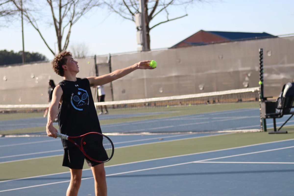 Senior Ben Edwards prepares to serve the ball. Both teams play five matches in six days this week.